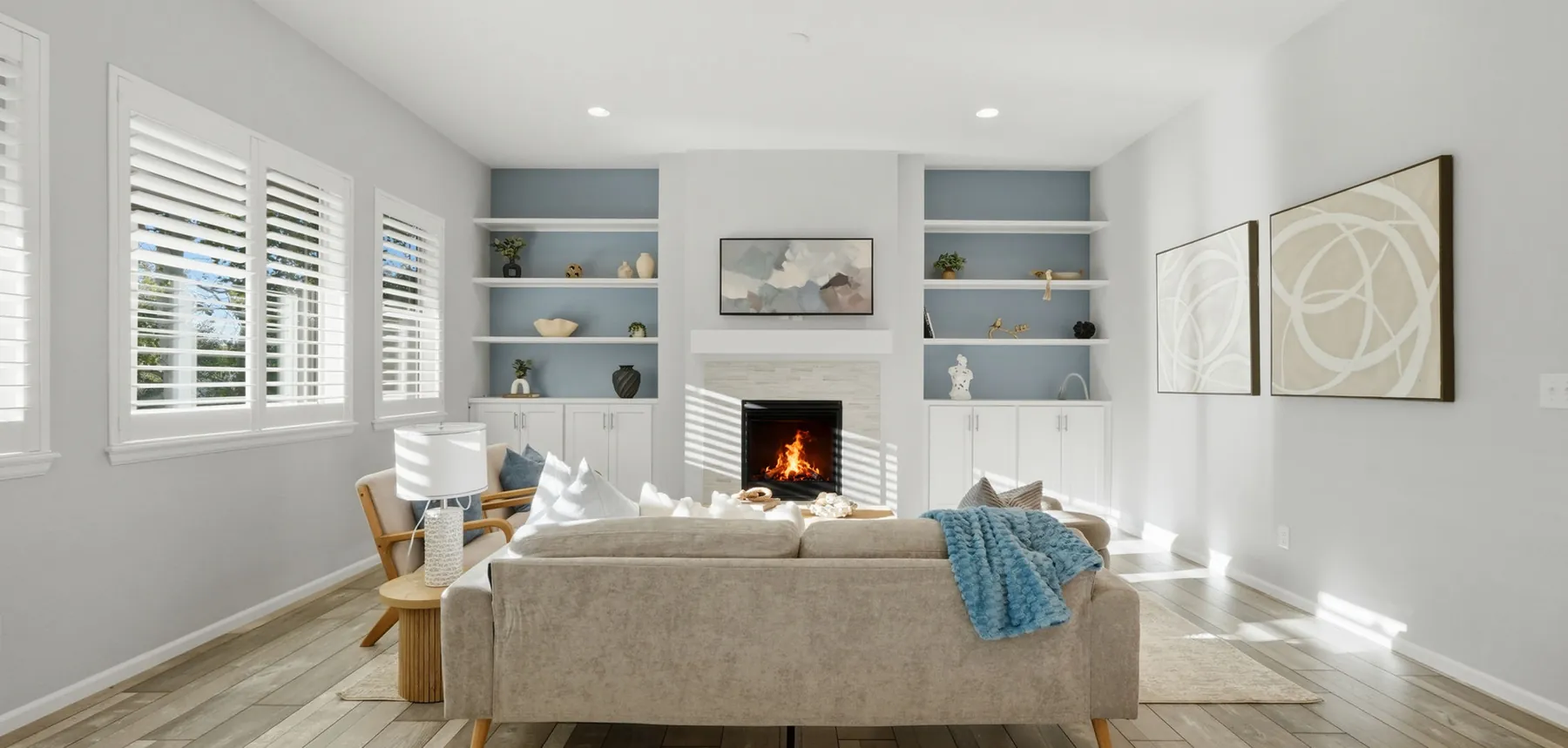 Staged living room with built-in shelves and a fireplace